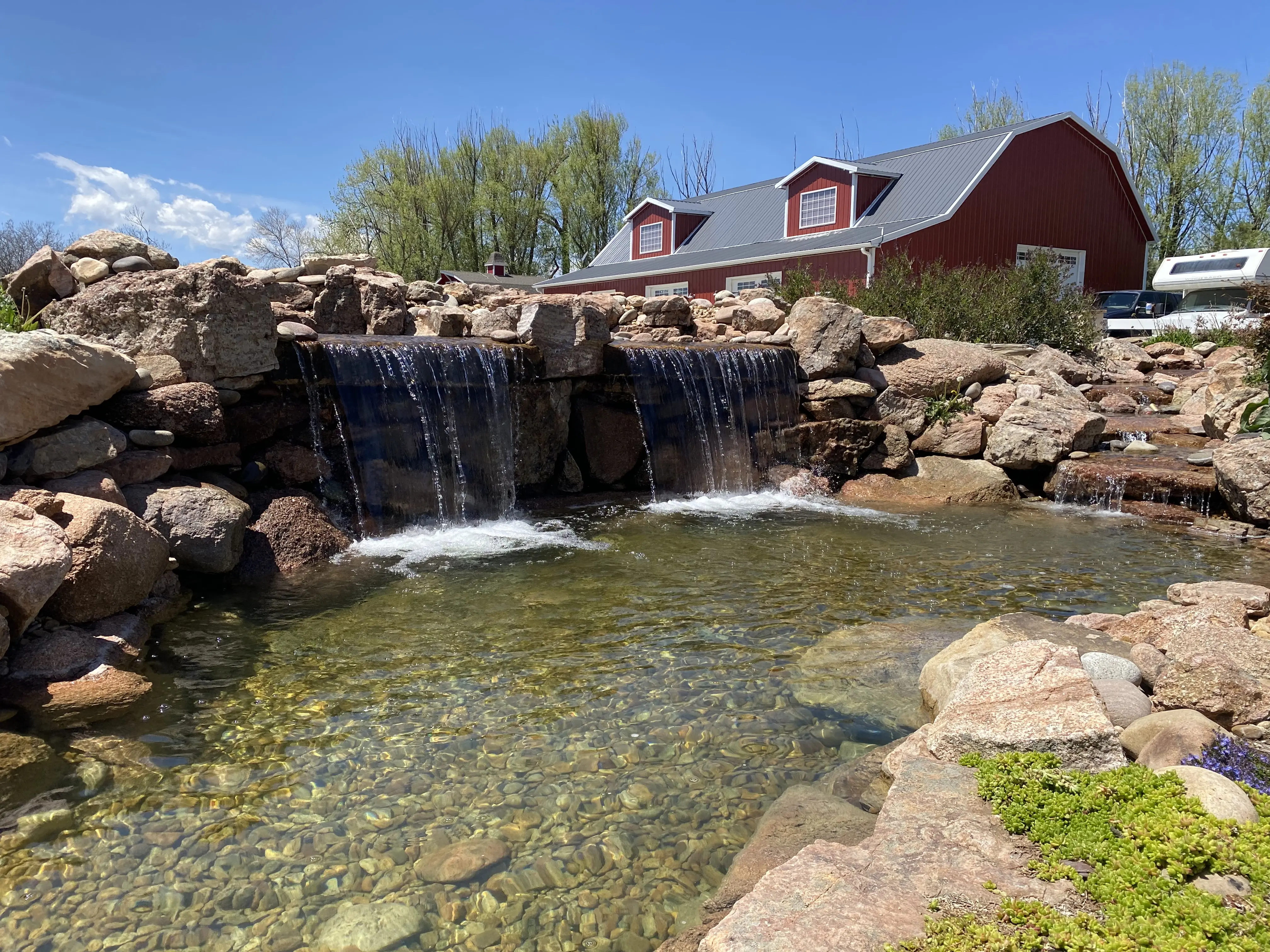 shallow lagoon with double water falls and stream